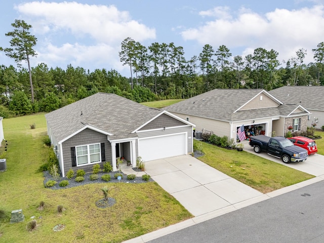 ranch-style house featuring central air condition unit, a front lawn, and a garage