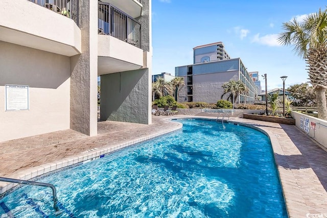 view of swimming pool featuring a patio