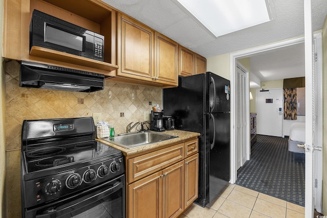 kitchen featuring black appliances, sink, ventilation hood, decorative backsplash, and light tile patterned flooring