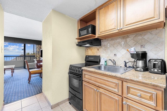 kitchen featuring backsplash, light tile patterned floors, sink, black appliances, and exhaust hood