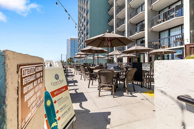 view of patio featuring a balcony