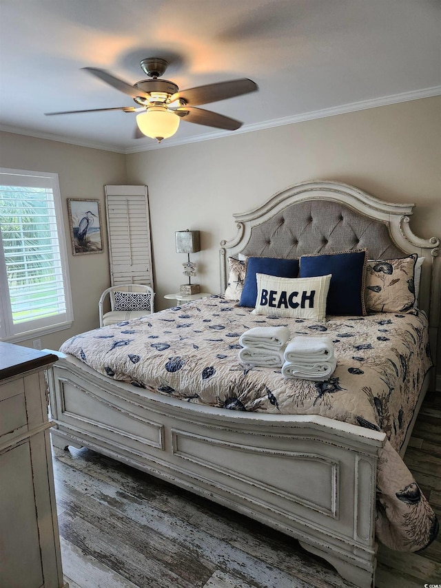 bedroom with crown molding, ceiling fan, and dark hardwood / wood-style flooring