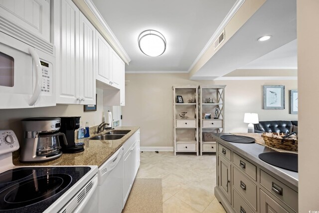 kitchen with ornamental molding, sink, light tile patterned floors, and white appliances