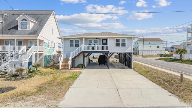 raised beach house with a carport and a porch