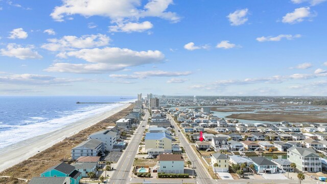 aerial view with a water view and a beach view