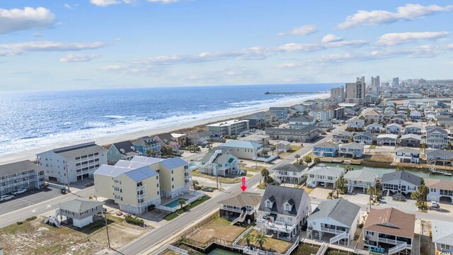 birds eye view of property with a water view and a view of the beach