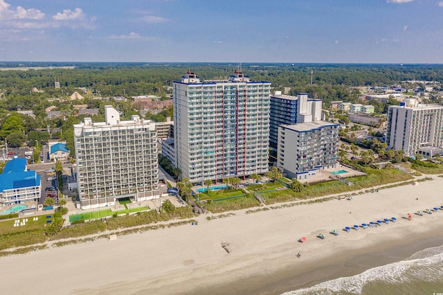 bird's eye view featuring a water view and a beach view