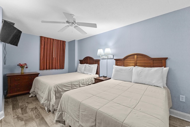 bedroom with ceiling fan and light hardwood / wood-style flooring