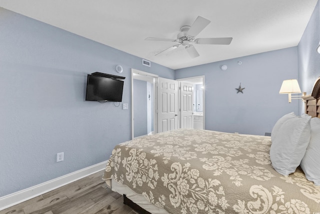 bedroom featuring ceiling fan, hardwood / wood-style flooring, and ensuite bathroom