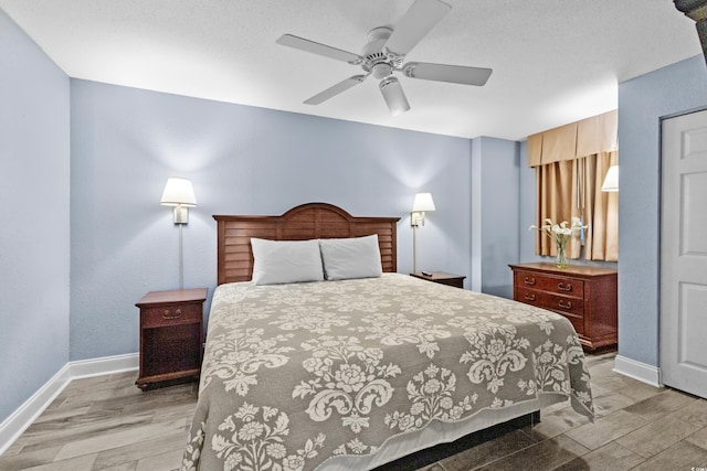 bedroom with ceiling fan and light hardwood / wood-style flooring