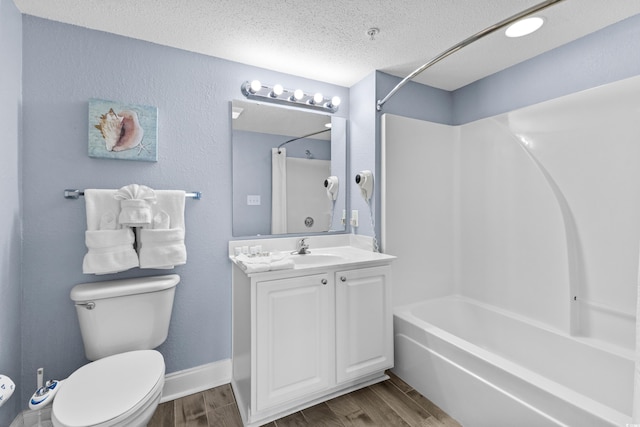 full bathroom featuring a textured ceiling, hardwood / wood-style flooring, shower / tub combination, vanity, and toilet