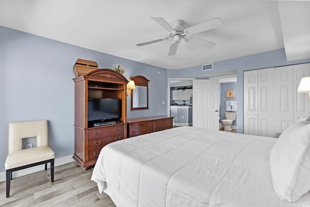 bedroom with light wood-type flooring, ensuite bath, and ceiling fan