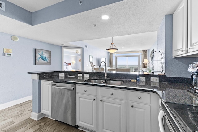 kitchen with stainless steel dishwasher, white cabinetry, sink, and light hardwood / wood-style flooring