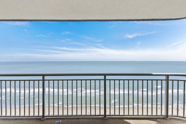 balcony with a water view and a beach view