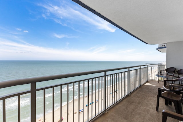 balcony with a view of the beach and a water view