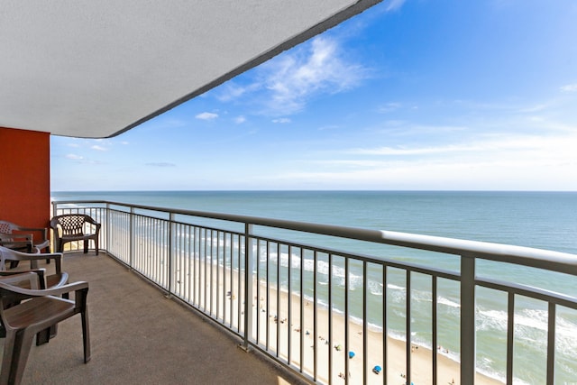 balcony with a water view and a beach view