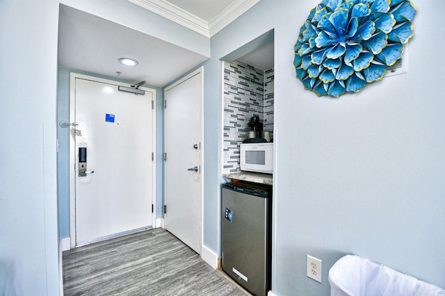 bathroom featuring crown molding and hardwood / wood-style floors