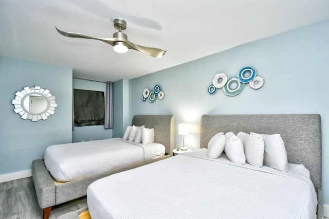 bedroom with ceiling fan and hardwood / wood-style floors