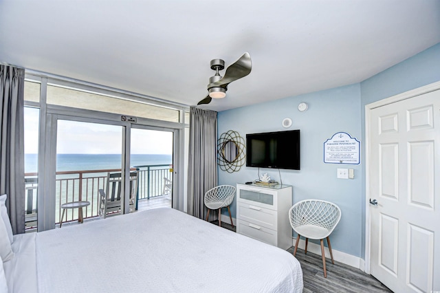 bedroom featuring access to outside, wood-type flooring, and ceiling fan