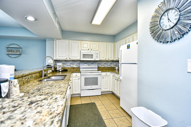 kitchen with white appliances, sink, decorative backsplash, stone counters, and light tile patterned flooring