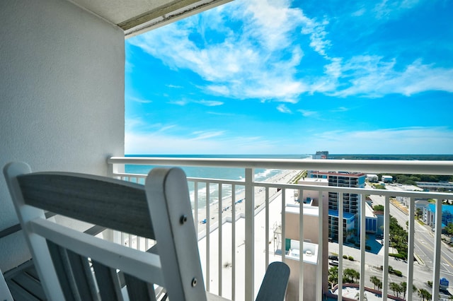 balcony with a water view and a beach view