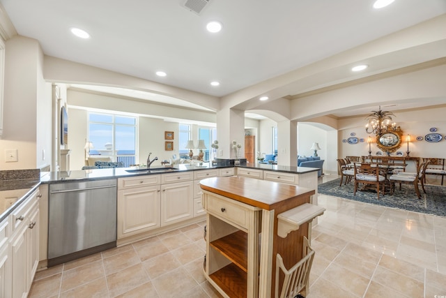 kitchen featuring a notable chandelier, butcher block countertops, dishwasher, kitchen peninsula, and sink