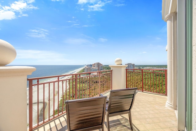 balcony with a beach view and a water view