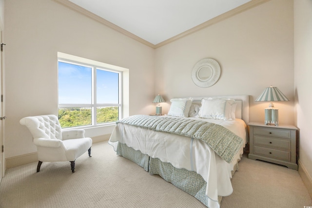 bedroom with crown molding and light colored carpet