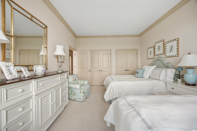 carpeted bedroom with crown molding and multiple closets