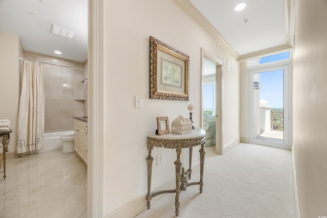 corridor featuring crown molding and light carpet