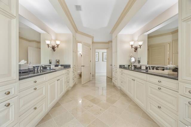 bathroom with toilet, ornamental molding, a notable chandelier, and vanity