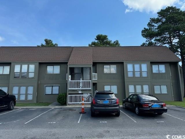 view of building exterior with uncovered parking