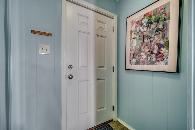 entryway with wood finished floors and baseboards