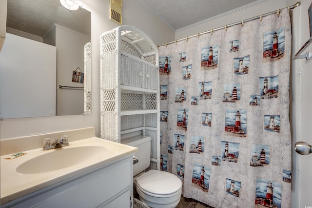 bathroom with visible vents, toilet, crown molding, and vanity