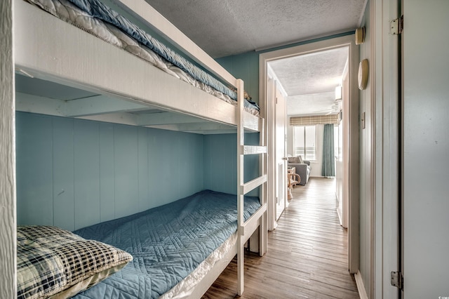 bedroom featuring a textured ceiling and wood finished floors