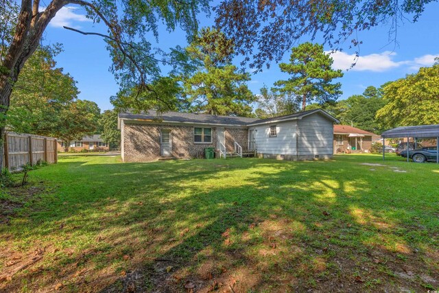 back of house with a yard and a carport