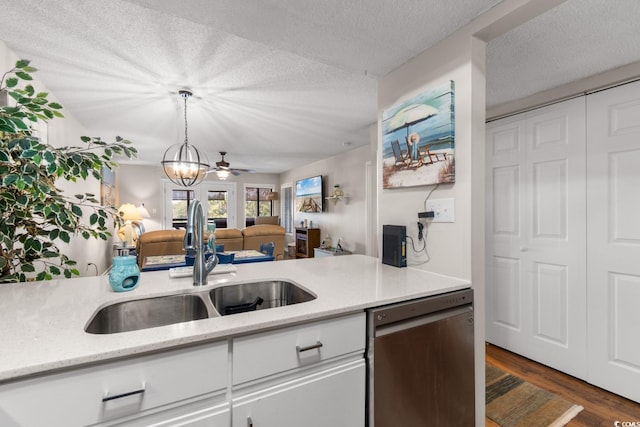 kitchen featuring a textured ceiling, light stone countertops, dark hardwood / wood-style flooring, dishwasher, and ceiling fan