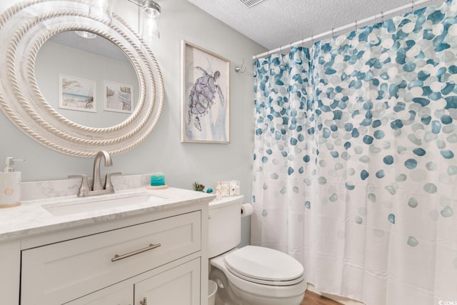 bathroom with a textured ceiling, vanity, a shower with shower curtain, hardwood / wood-style floors, and toilet