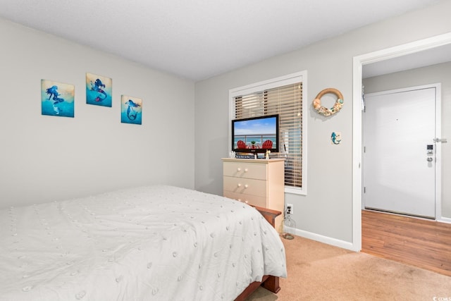 bedroom featuring light carpet