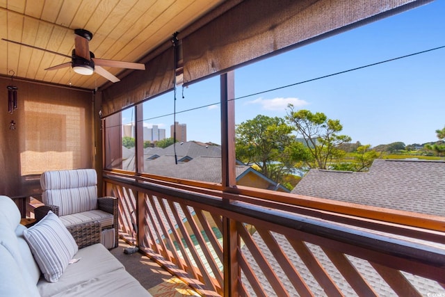 sunroom featuring ceiling fan and wooden ceiling