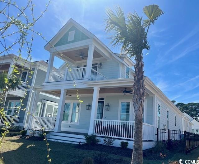 view of front of home with a balcony, ceiling fan, and a porch