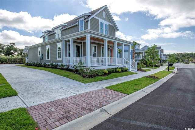 view of front of home with covered porch and a front yard