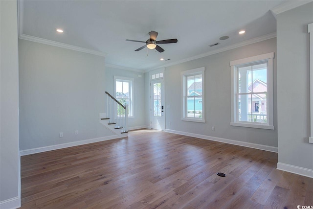 empty room with ceiling fan, wood-type flooring, and ornamental molding