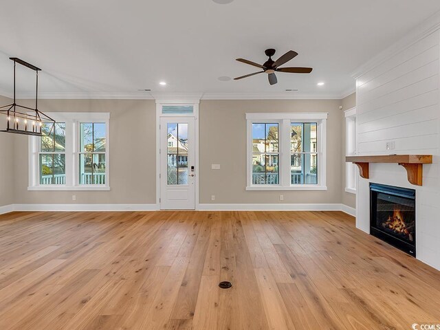 unfurnished dining area featuring crown molding, wood-type flooring, a chandelier, and sink