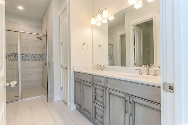 bathroom featuring tile patterned flooring, vanity, and an enclosed shower