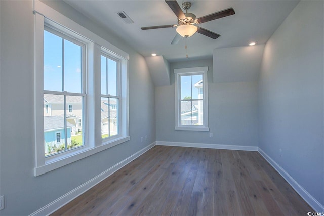 spare room featuring dark wood-type flooring and ceiling fan