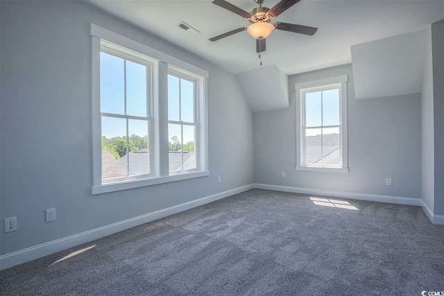 additional living space with ceiling fan and dark colored carpet