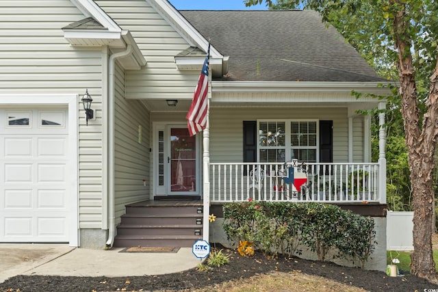 property entrance with covered porch and a garage