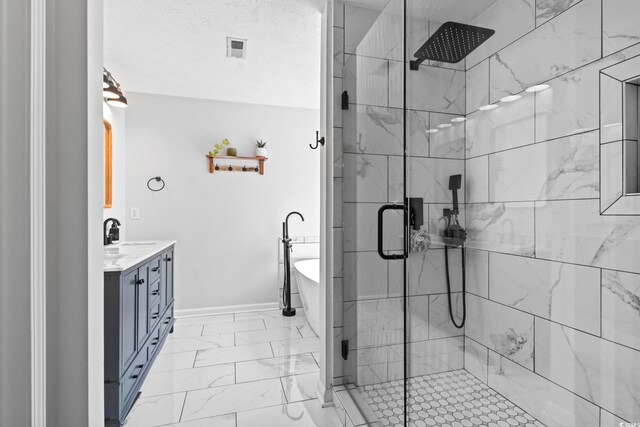 bathroom featuring vanity, a textured ceiling, and separate shower and tub