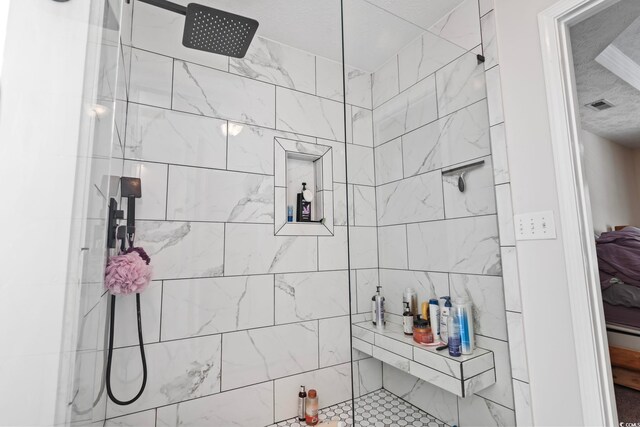 bathroom with a tile shower